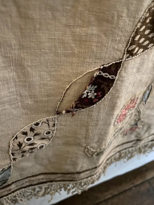 Detail showing wear on the appliquéd cotton patches on Cowper's historic quilt.