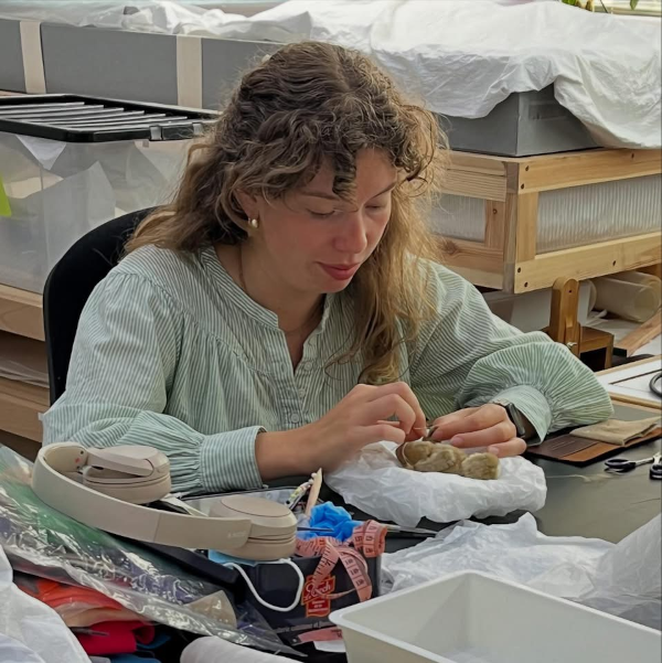 Textile conservator working in a studio setting